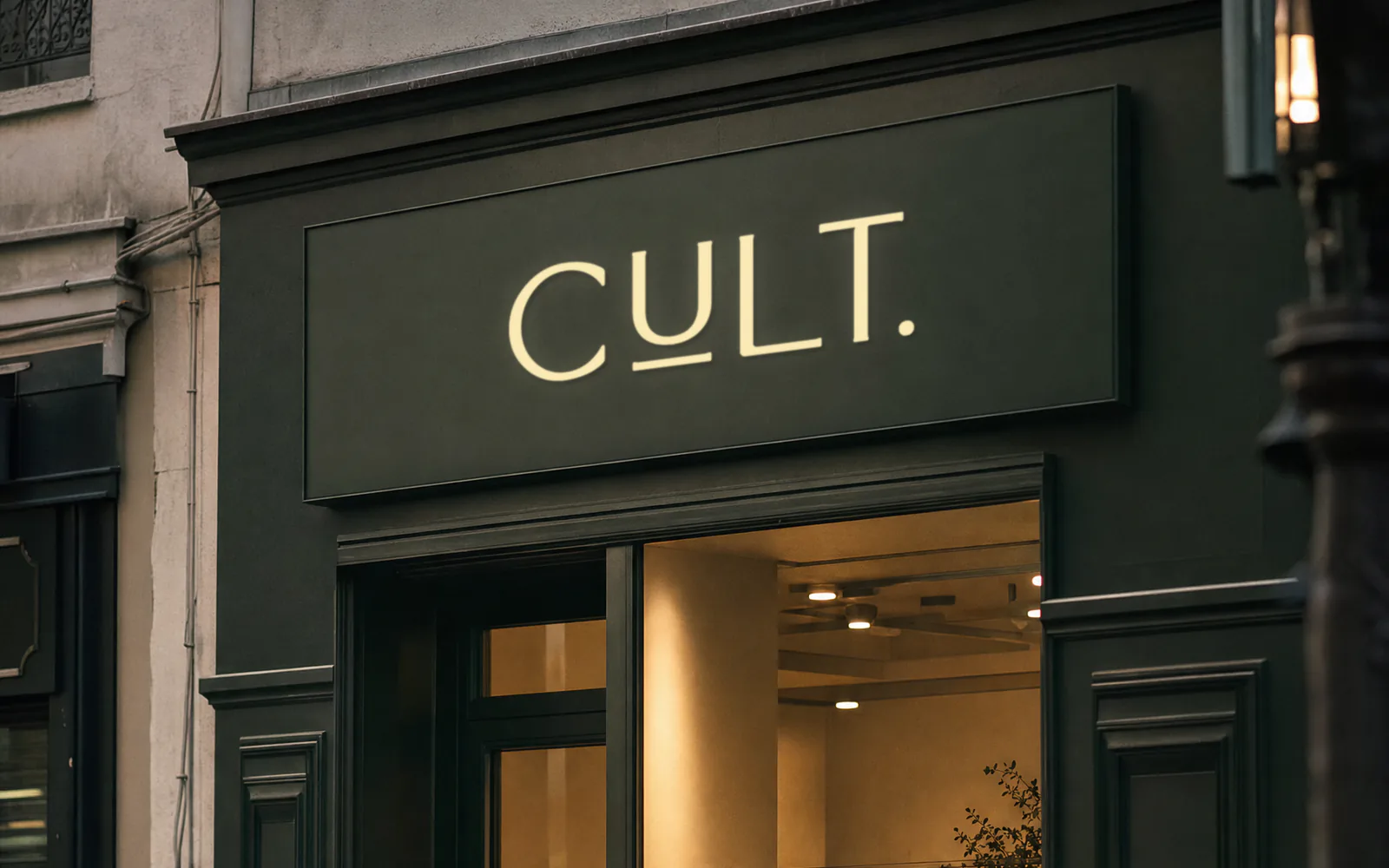 CULT storefront mockup: the cream CULT. wordmark on a dark green fascia
